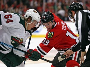 Jonathan Toews #19 of the Chicago Blackhawks and Mikael Granlund #64 of the Minnesota Wild wait for the referee to drop the puck on a face-off in Game One of the Western Conference Semifinals during the 2015 NHL Stanley Cup Playoffs at the United Center on May 1, 2015 in Chicago, Illinois. The Blackhawks defeated the Wild 4-3.  (Photo by Jonathan Daniel/Getty Images)