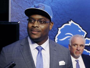 Detroit Lions first round draft pick guard Laken Tomlinson addresses the media during a news conference on Friday, May 1, 2015 in Allen Park, Mich. At right, is Senior Vice President of Communications Bill Keenist. (AP Photo/Carlos Osorio)