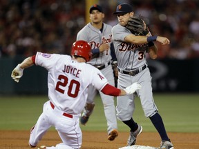 Detroit Tigers second baseman Ian Kinsler (3) makes the relay to first over Los Angeles Angels’ Matt Joyce (20), to get the Angels' Chris Iannetta at first or a double play, with shortstop Jose Iglesias watching, during the fourth inning of a baseball game in Anaheim, Calif., Friday, May 29, 2015. (AP Photo/Alex Gallardo)
