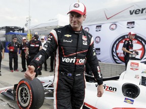 Will Power gives a thumbs-up after winning the pole for the first race of the IndyCar Detroit Grand Prix auto racing doubleheader Friday, May 29, 2015, in Detroit. (AP Photo/Carlos Osorio)