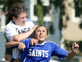 St. Anne's Emma Collins, right, battles Ursuline's Jordan Carr during the SWOSSAA senior girls soccer final Thursday in Chatham. The Saints dropped a 2-1 decision on penalty kicks. (MARK MALONE/The Daily News)