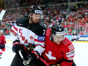 Sean Couturier (R) of Canada and Damien Brunner (L) of Switzerland battle for the puck during the IIHF World Championship group A match between Switzerland and Canada at o2 Arena on May 10, 2015 in Prague, Czech Republic.  (Photo by Martin Rose/Getty Images)