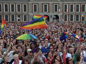 Thousands of people celebrate in Dublin Castle Square as the result of the referendum is relayed on May 23, 2015 in Dublin, Ireland. Voters in the Republic of Ireland were taking part in a referendum on legalising same-sex marriage on Friday. The referendum was held 22 years after Ireland decriminalised homosexuality with more than 3.2m people being asked whether they want to amend the country's constitution to allow gay and lesbian couples to marry. Ireland voted overwhelmingly to legalise same-sex marriage in a historic referendum. More than 62% voted in favour of amending the country's constitution to allow gay and lesbian couples to marry. It is the first country in the world to legalise same-sex marriage through a popular vote. (Photo by Charles McQuillan/Getty Images)