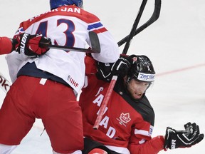 Belle River's Aaron Ekblad, right, is checked by Jan Kovar of the Czech Republic at the world hockey championship in Prague. (AFP PHOTO / JONATHAN NACKSTRANDJONATHAN NACKSTRAND/AFP/Getty Images)