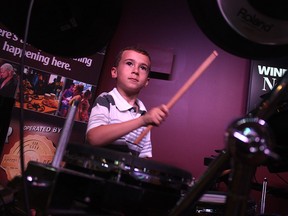 Eight-year-old drummer-extraordinaire Alex Bonadonna performs with his father John-Paul in the Windsor Star News Cafe on Friday, May 8, 2015. (TYLER BROWNBRIDGE/The Windsor Star)
