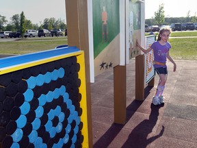 Arta Giles, 9, of Amherstburg, on the accessible playground she helped build near the Libro Credit Union Centre. (Jason Kryk / The Windsor Star)