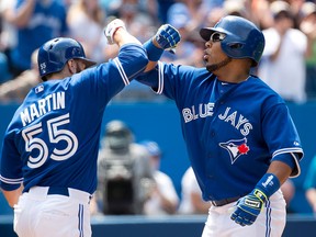 Toronto Blue Jays DH Edwin Encarnacion, right, celebrates his two-run home run with teammate Russell Martin, left, against the Seattle Mariners during fifth inning AL baseball action in Toronto on Sunday, May 24, 2015. THE CANADIAN PRESS/Nathan Denette