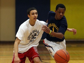 Isiah Osborne, left, and Alston Gayle chase down a loose ball during the high school all star game in this file photo.   (TYLER BROWNBRIDGE/The Windsor Star)