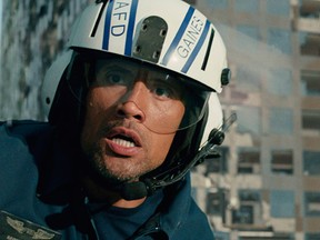 This photo provided by Warner Bros. Pictures shows Dwayne Johnson as Ray in a scene from the action thriller, "San Andreas." The movie releases in theaters on May 29, 2015. (Courtesy Warner Bros. Pictures via AP)