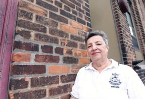 WINDSOR, ON. MAY 11, 2015. Shirley Beresford, president of the Navy League of Windsor poses next to back wall of the HMCS Hunter building on Ouellette Ave. on Monday, May 11, 2015 in Windsor, ON. The bricks have names of local sailors carved during the 1940s.  (DAN JANISSE/The Windsor Star)
