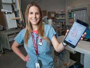 Kaitlyn Sheehan, a registered nurse in the cardiac cath lab at Windsor Regional Hospital - Ouellette Campus, displays a smart phone app called Stent Trackr, in the cath lab, Tuesday, May 12, 2015.  The smartphone app lets cardiac patients store stent information, provide medication and appointment reminders, as well as provide educational material on cardiac health.  (DAX MELMER/The Windsor Star)