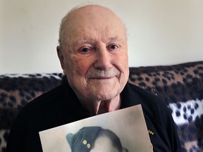 Harry Delisle, 93, who served with Royal Canadian Air Force at his Windsor home on Thursday, May 7, 2015. Delisisle is holding a photo of himself at age 23.  (DAN JANISSE/The Windsor Star)