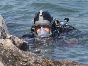 A diver with the Ontario Provincial Police works along the Detroit river waterfront in downtown Windsor, ON. on Thursday, May 7, 2015.  (DAN JANISSE/The Windsor Star)