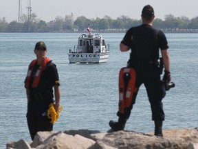 Members of the Ontario Provincial Police dive team work along the Detroit river waterfront in downtown Windsor, ON. on Thursday, May 7, 2015.  (DAN JANISSE/The Windsor Star)