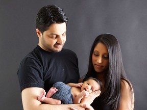 Omar and Natasha Rajani of Toronto pose with their with baby Zain in this recent handout photo. A Canadian woman is the first mother to give birth after undergoing a new procedure that boosts the health of women's eggs to improve the success rate of in-vitro fertilization. Natasha Rajani, 34, of Toronto gave birth to son Zain about three weeks ago. THE CANADIAN PRESS/HO - Stacey Lee Robson