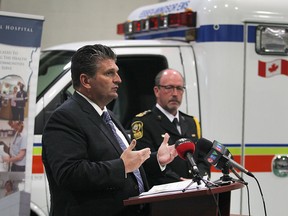 David Musyj, (L) president and CEO of the Windsor Regional Hospital speaks at a media conference on Wednesday, May 20, 2015, in Windsor, ON. regarding changes to the ambulance transportation of less acute patients to local emergency rooms. Bruce Krauter, Chief of the Essex-Windsor Emergency Medical Services looks on.  (DAN JANISSE/The Windsor Star)