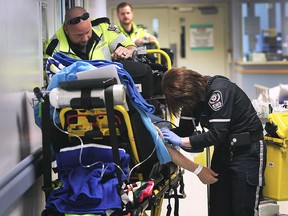 Paramedics with the Essex-Windsor Emergency Medical Services are shown in the emergency department at the Windsor Regional Hospital Ouellette Campus on Wednesday, May 20, 2015. Local health officials announced changes that would allow paramedics to spend less time with "ambulance off load delays" such as the individuals shown here.   (DAN JANISSE/The Windsor Star)