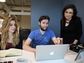 Sam Burton, left, and Jon Donais work with Nicole Anderson, director of the University of Windsor EPICentre on May 15, 2015.  (DAN JANISSE/The Windsor Star)