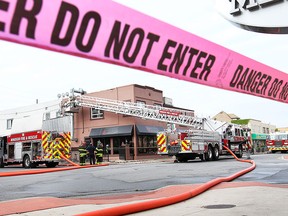 Firefighters are shown at the scene of a fire on Erie St. at Marentette on Thursday, May 21, 2015. in Windsor, ON. The blaze did significant damage to the street level Masaya Cafe and second floor apartments. (DAN JANISSE/The Windsor Star)