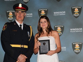 Kelsey McDaniel receives a Citizen Citation Award from Windsor Police Chief Al Frederick during the Windsor Police Exemplary Service Awards held at the St. Clair Centre for the Arts on May 12, 2015.  (JASON KRYK/The Windsor Star)