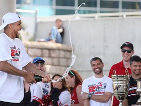 Kevin Loiselle pops a bottle of champaign during a celebration for the Windsor Express' second consecutive NBL Championship at the Riverfront Festival Plaza, Sunday, May 3, 2015.  (DAX MELMER/The Windsor Star)