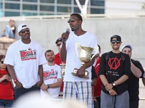 Windsor Express player, Chris Commons, gives a speech to fans while holding the NBL championship trophy during a celebration for the Windsor Express' consecutive NBL Championship at the Riverfront Festival Plaza, Sunday, May 3, 2015.  (DAX MELMER/The Windsor Star)