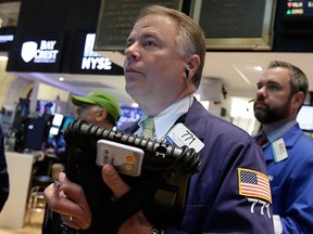 Trader F. Hill Creekmore, center, works on the floor of the New York Stock Exchange Thursday, May 21, 2015. U.S. stocks edged higher in early trading. Energy stocks rose more than the rest of the market as the price of oil climbed. (AP Photo/Richard Drew)