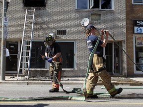 Firefighters clean up after putting out a fire in the 1200 block of Wyandotte Street East in Windsor on Saturday, May 2, 2015.                   (TYLER BROWNBRIDGE/The Windsor Star)