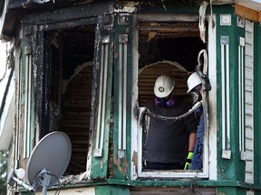Fire investigators work the scene of an over night fire on Church Street in Windsor on Wednesday, May 6, 2015. Windsor Police officers rushed in to the building to save several people. (TYLER BROWNBRIDGE/The Windsor Star)