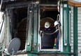 Fire investigators work the scene of an over night fire on Church Street in Windsor on Wednesday, May 6, 2015. Windsor Police officers rushed in to the building to save several people. (TYLER BROWNBRIDGE/The Windsor Star)