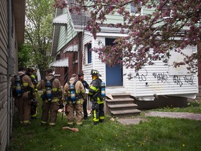 Windsor police and fire crews tend to a suspected intentionally set fire in an abandoned home on Edison St., Sunday, May 10, 2015.  (DAX MELMER/The Windsor Star)