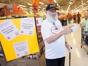 Bruce Dalrymple, a volunteer with The Salvation Army, hands out wish lists for the Healthy Choices Food Drive in support of The Salvation Army at the Real Canadian Superstore, Saturday, May 23, 2015.   (DAX MELMER/The Windsor Star)