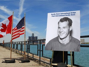 A photograph of Gordie Howe is displayed on the riverfront after a news conference, Thursday, May 14, 2015, in Windsor, announcing that a planned bridge connecting Detroit, rear, and Windsor, will be named after the hockey Hall of Famer. The yet-to-be built Gordie Howe International Bridge is expected to be operational in 2020. (Romain Blanquart/Detroit Free Press via AP, Pool)