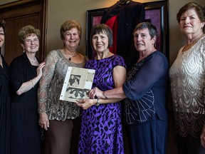 Janette O'Brien, Audrey Wirch, Lucia Eugenie, Shirley Grondin, Ursula Verstraete, and Pat King display a Windsor Star article from their graduation in 1965. (JESSELYN COOK/The Windsor Star)