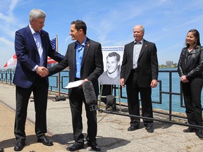 Prime Minister Stephen Harper and Gordie Howe's children, Murray Howe, Marty Howe and Cathy Howe announce that the Detroit River International Crossing will be named the Gordie Howe International Bridge, on the waterfront, in Windsor, Ontario, Thursday May 14, 2015. THE CANADIAN PRESS/Dave Chidley