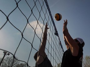 Josh Rankin and Julian Miletic play volleyball late in the afternoon during the San Dune Beach Volleyball league in Windsor, Ontario on May 6, 2015.  (JASON KRYK/The Windsor Star)