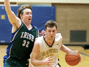 Chatham-Kent Golden Hawks' Ian Smart, right, drives against Eric Steeves of the St. Patrick's Fighting Irish during the second half of a LKSSAA senior boys 'AA-AAAA' basketball game at Chatham-Kent Secondary School in Chatham, Ont., on Tuesday, Jan. 13, 2015. Mark Malone/Chatham Daily News/QMI Agency