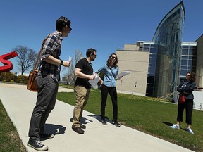 Greg Atkinson, Kevin Alexander and Laura Diotte (left to right) lead a group on a Jane's Walk tour in downtown Windsor on Saturday, May 2, 2015.                  (TYLER BROWNBRIDGE/The Windsor Star)