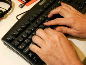 Hands at a computer keyboard are shown in this 2008 file photo. (Frank Franklin / Associated Press)