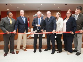 LaSalle's Mayor Ken Antaya, centre left, is joined by town councillor's, from left, Mike Akpata,Deputy Mayor Marc Bondy, Terry Burns, Crystal Meloche, Sue Desjarlais, and  Jeff Renaud as they cut a ribbon to inaugurate the new council chambers in the Civic Centre, Sunday, May 31, 2015.