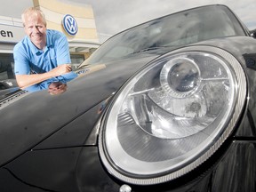 In this 2010 file photo, Chris Leavens stands next to a Porsche Carrera 4S at his Volkswagen dealership in London.  Leavens is opening an Audi dealership in Windsor. (CRAIG GLOVER The London Free Press)