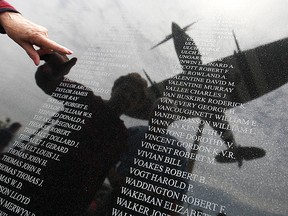 Ida Totten locates a relative, Max Perkins, who served in the Air Force during WWII, on the Honour Wall during an unveiling event, Sunday, May 24, 2015.  The Honour Wall is dedicated to those who served in the Air Force in World War II from the Windsor and Essex County area.  (DAX MELMER/The Windsor Star)