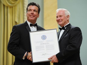 Governor General David Johnston presents Marty Beneteau of The Windsor Star with a citation of merit during the Michener Awards for meritorious public service in journalism at Rideau Hall in Ottawa on Tuesday, June 12, 2012. THE CANADIAN PRESS/Sean Kilpatrick