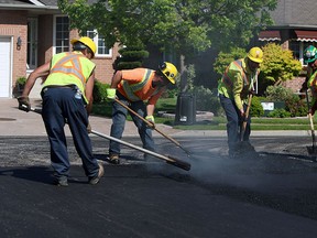 A paving crew lays asphalt in the east end of Windsor on Friday, May 22, 2015.              (TYLER BROWNBRIDGE/The Windsor Star)