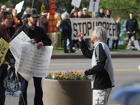 A man taunts protesters who staged a rally targeted at Prime Minister Stephen Harper who is Windsor on Wednesday, May 13, 2015.            (TYLER BROWNBRIDGE/The Windsor Star)