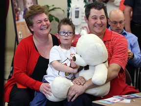 Lisa, Thomas and Jason Dunn (left to right) take part in a press conference to announce the new Ronald McDonald House which will open inside the Windsor Regional Hospital in Windsor on Friday, May 1, 2015. (TYLER BROWNBRIDGE/The Windsor Star)