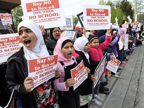 Parents and children take part in a protest against the new sex education curriculum outside of the Greater Essex County District School Board offices in Windsor on Wednesday, May 6, 2015.                  (TYLER BROWNBRIDGE/The Windsor Star)