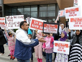 Parents and children take part in a protest against the new sex education curriculum outside of the GECDSB offices in Windsor on Wednesday, May 6, 2015.                  (TYLER BROWNBRIDGE/The Windsor Star)
