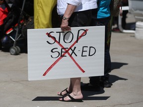 A protester holds a sign reading 'stop sex-ed' at a rally protesting Ontario's new sex education curriculum at Charles Clark Square, Saturday, May 23, 2015.   (DAX MELMER/The Windsor Star)
