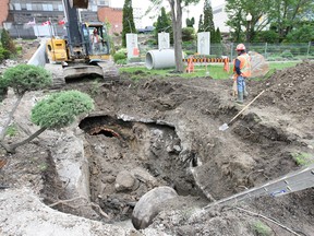 Workers repair a collapsed sewer line in the Dieppe Park in Windsor, ON Tuesday, May 19, 2015.  (DAN JANISSE/The Windsor Star)